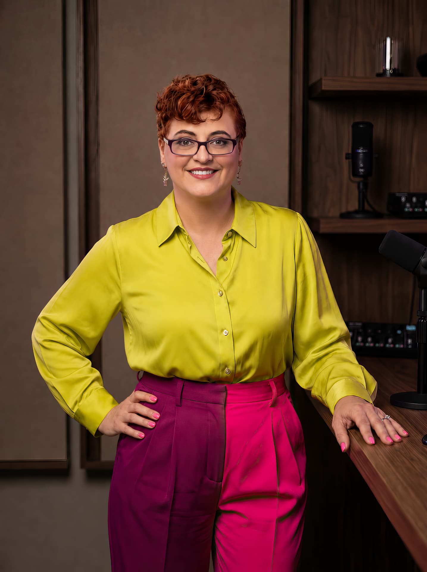 Nadia in a lime-yellow blouse and fuchsia trousers in a professional studio